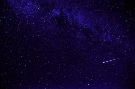 purple night starry sky with shooting star and milky way