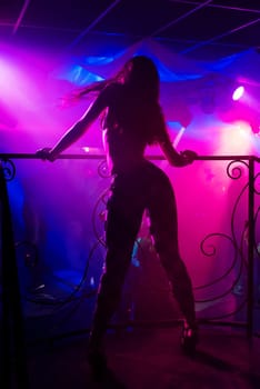 young girl dancer go-go on the nightclub scene with sexy figure dancing