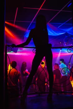 silhouette of a go-go dancer girl on stage in a nightclub