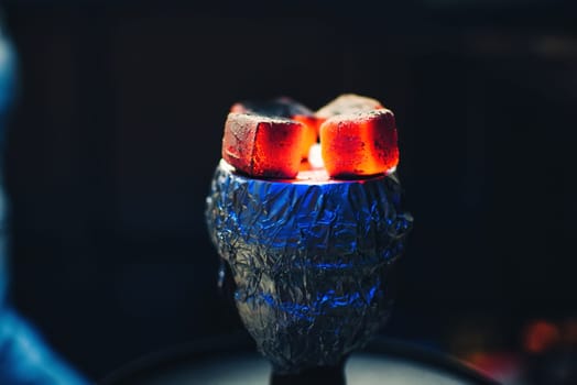 coals of the Shisha on the foil on the bowl with tobacco Smoking and red hot