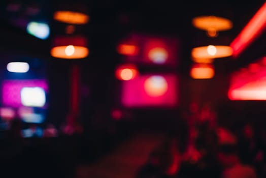interior of night club with a lubricated and blurred background with bokeh from bright lights