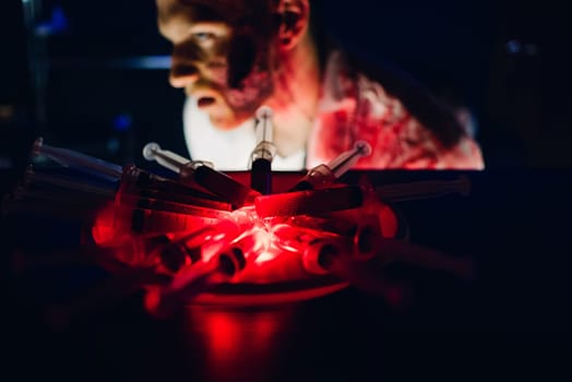 syringes with blood and a scary bloody monster on Halloween with a frightening dark background at the club