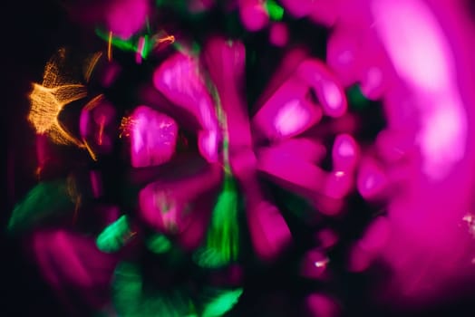 abstract pattern and bright pink purple and green glow in a circular shape and the blurred background