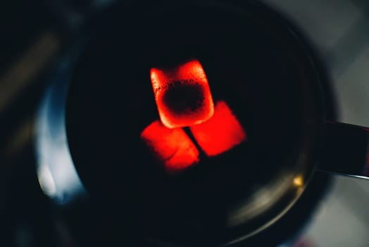 hot coals for Shisha bowl tobacco Smoking and relaxation closeup on dark background