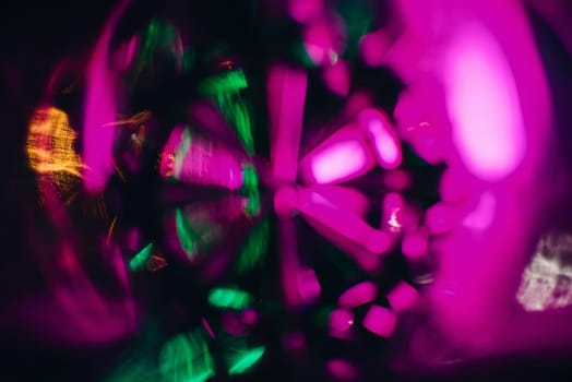 abstract texture pattern is photographed through the glass of the round glass green purple bright glow