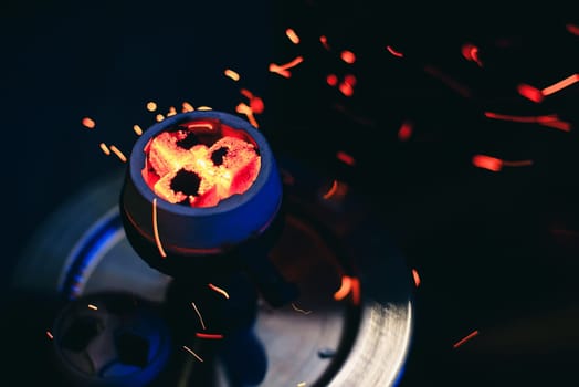 coals in the hookah bowl of Smoking hot red with bold sparks