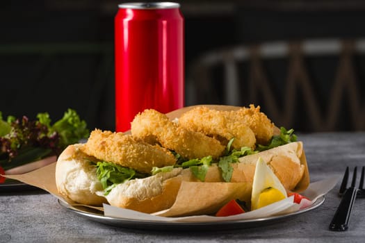 Deep fried squid in bread with greens on the side. Squid sandwich