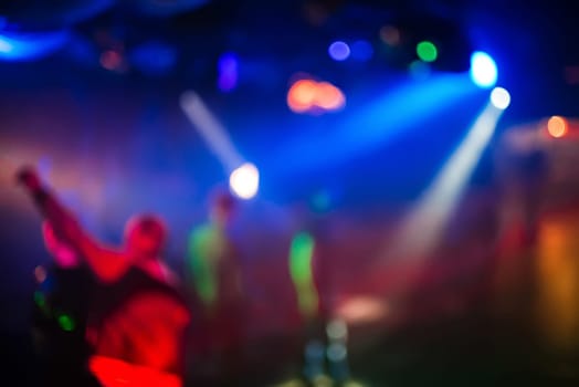 blurred abstract background for party with multi-coloured light from the bright spotlights and spots bokeh