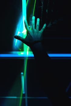 man's hand is raised up in a nightclub on a dark background