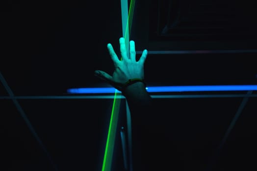 man's hand is raised up in a nightclub on a dark background