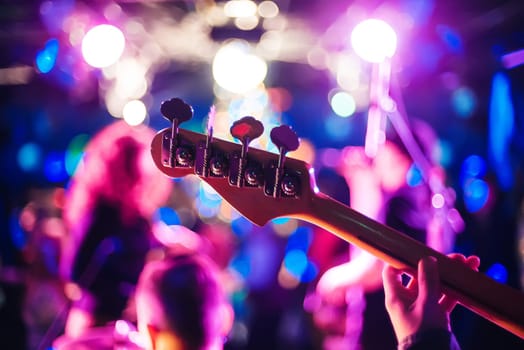 guitar neck at a live concert close-up on a blurry background