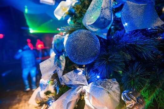 beautiful Christmas ball on the branches of the Christmas tree with the blue illuminated and blurred background