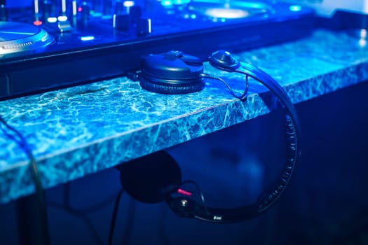 professional DJ headphones in a booth at party in nightclub