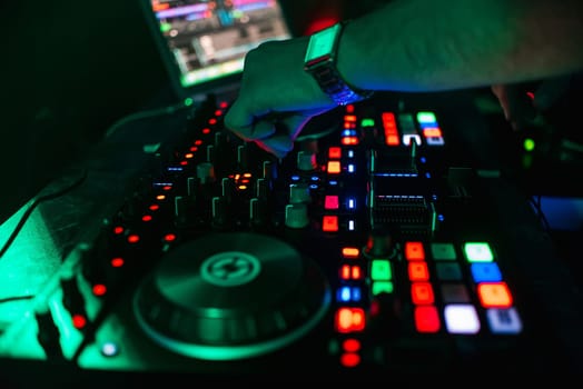 hand of the DJ controlling and moving the mixers in a music remote