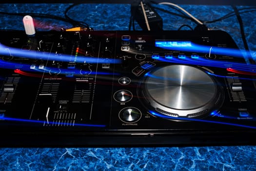 music dj panel mixer in a booth at a nightclub party