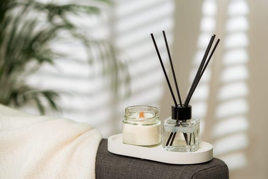 Aroma diffuser bottle with sticks in living room, close up