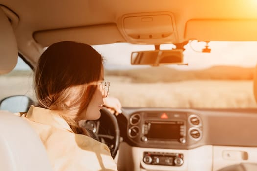 Relaxed business woman talking on video call on phone in automobile. Rested female professional saying bye on video chat in business car. Beautiful lady making video message in luxury car.