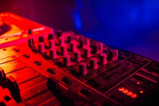music dj panel mixer in a booth at a nightclub party