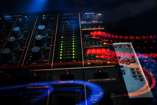 control buttons and mixing music on professional equipment for mixing and DJ