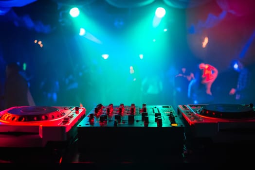 music dj panel mixer in a booth at a nightclub party