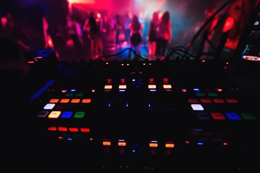 glowing colorful buttons on the mixer DJ party night club for dancing
