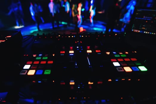 glowing buttons professional Board for mixing and music at party in night club with a dark colored background