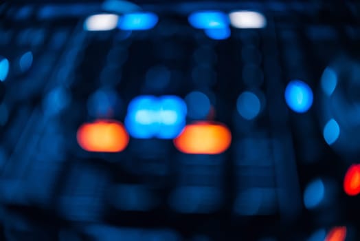 blurred glowing button, mixer DJ for mixing and controlling music in a nightclub