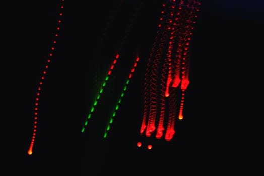 colored traces from the effects on a long exposure from musical equipment on a black background