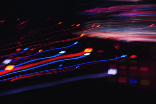 abstract colored traces from the effects on a long exposure from light buttons musical equipment
