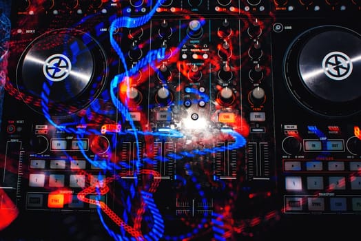 professional DJ Board with mixer for discs with multi-colored traces of light effects with long exposure