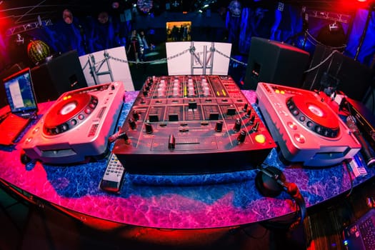 music dj panel mixer in a booth at a nightclub party