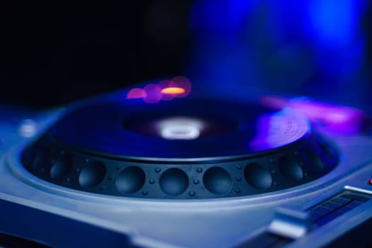 DJ setup for playing contemporary music with blurred colored background