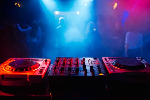 music dj panel mixer in a booth at a nightclub party