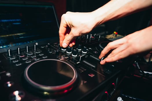 hands of DJ controllers for music on a professional mixer for mixing music