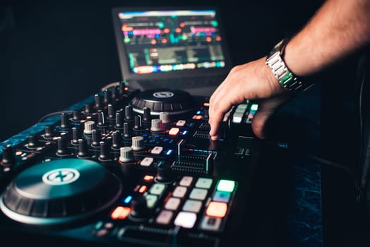 DJ mixes and manages music on a professional contemporary music Board