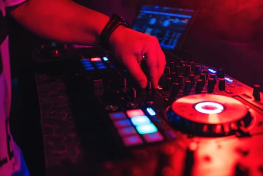 DJ managing regulators and volume of the music at party in night club