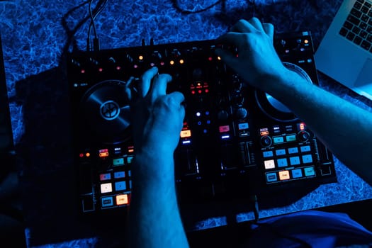 mixer and DJ booth in the nightclub with hands in night club on party
