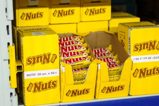 Tyumen, Russia-March 02, 2024: Nuts packets is neatly stacked on a shelf, each featuring for shoppers in a market environment.