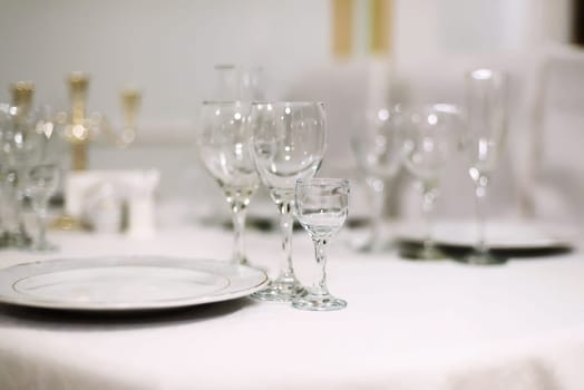 glasses for alcoholic beverages on the festive table in the restaurant