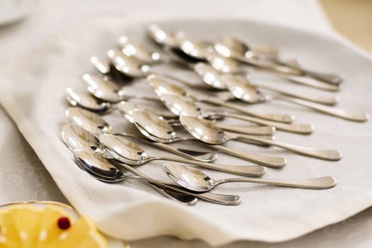group of teaspoons on tablecloth on a table in a restaurant
