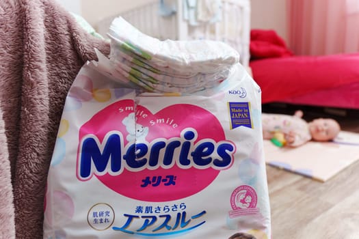 Tyumen, Russia-March 02, 2024: Merries diapers is casually placed on top of a wooden floor, showcasing the brands logo prominently.