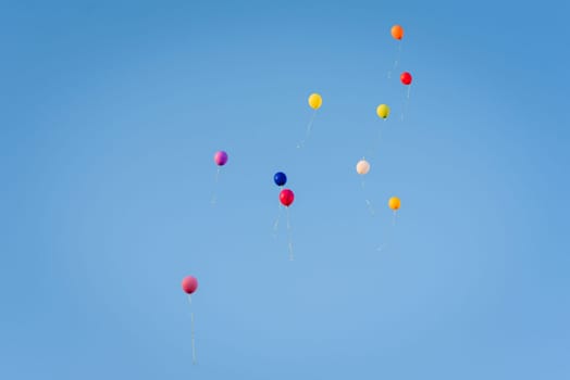 group of air colored gel balls flying against the sky