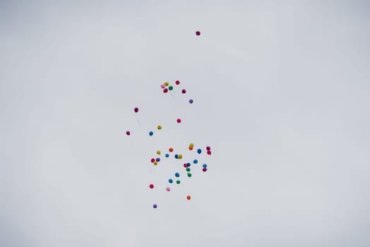 group of air colored gel balls flying against the sky