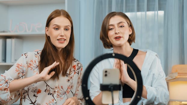 Two influencer partner shoot live streaming vlog video review makeup prim social media or blog. Happy young girl with cosmetics studio lighting for marketing recording session broadcasting online.