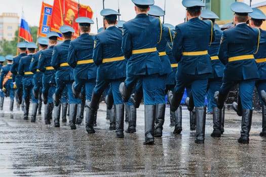 Russian military marches on the festive parade on the square from the back