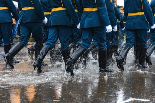 feet of the Russian military in boots marching on the festive march