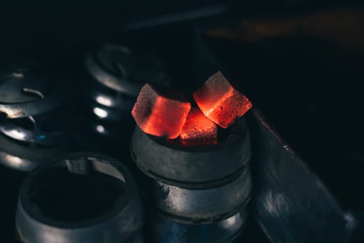 hot red coals for hookah in Cup close up