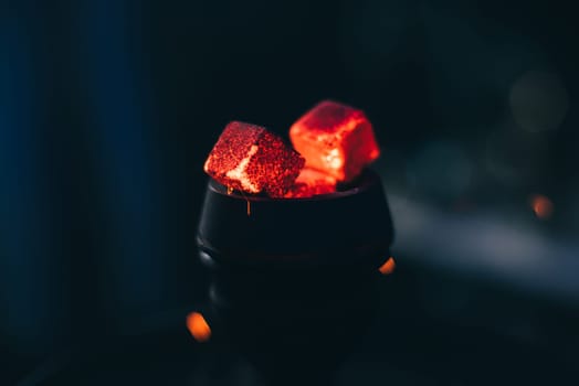 hot red coals for hookah on dark background close up
