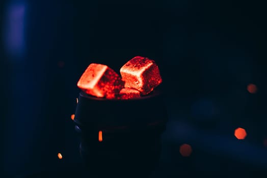 hot red coals with hookah sparks in metal bowl for Shisha Smoking and traditional Asian relaxation