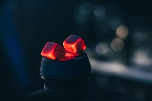 hot red coals with hookah in bowl for Shisha Smoking and traditional Asian relaxation close up